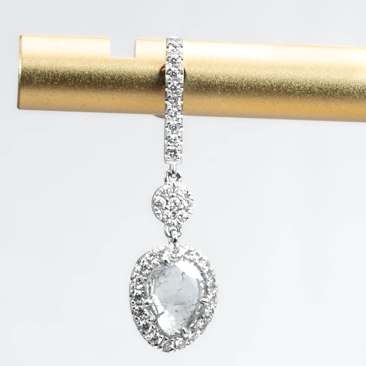 close up view of salt and pepper diamond slice earrings on white background