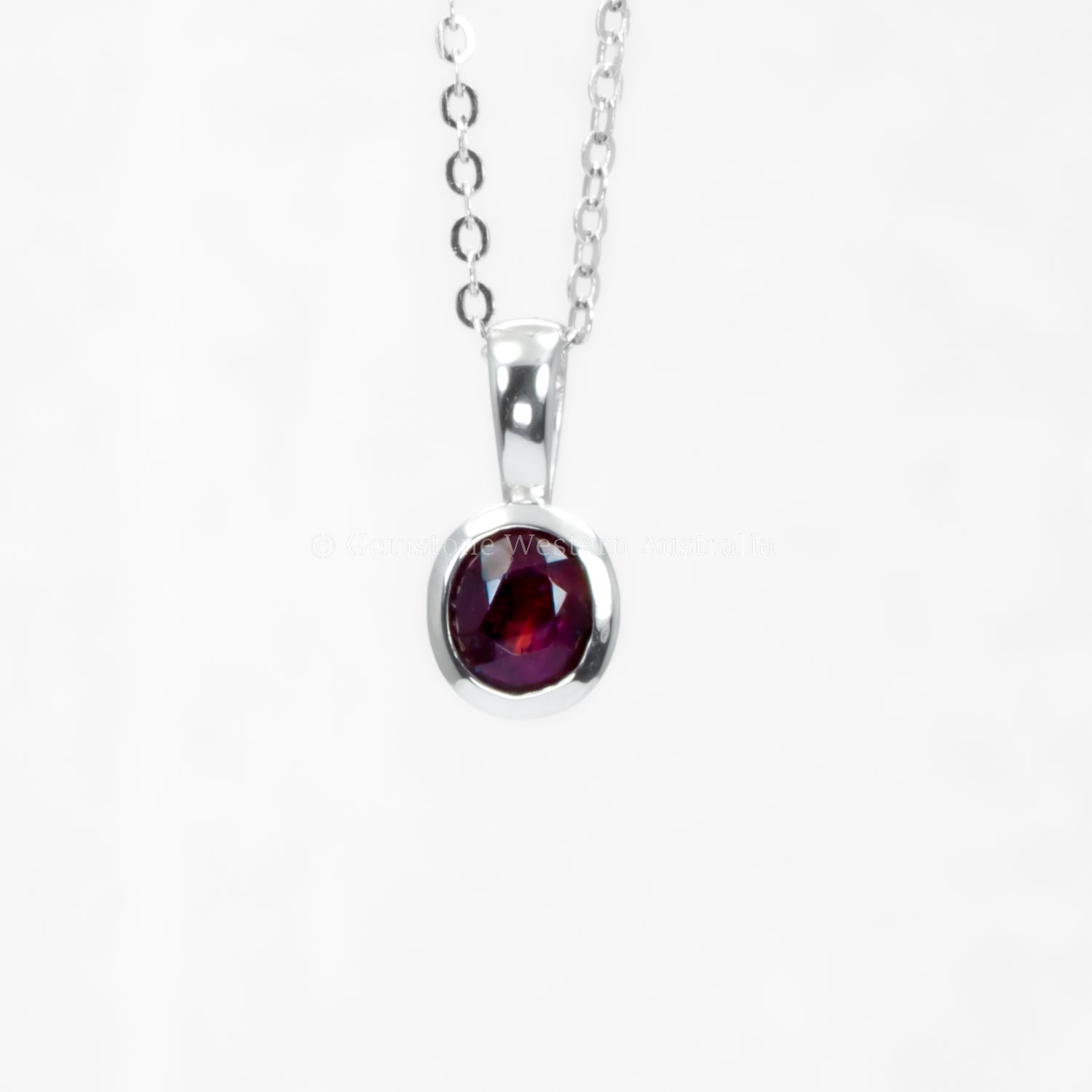 Platinum pendant with natural ruby in white background