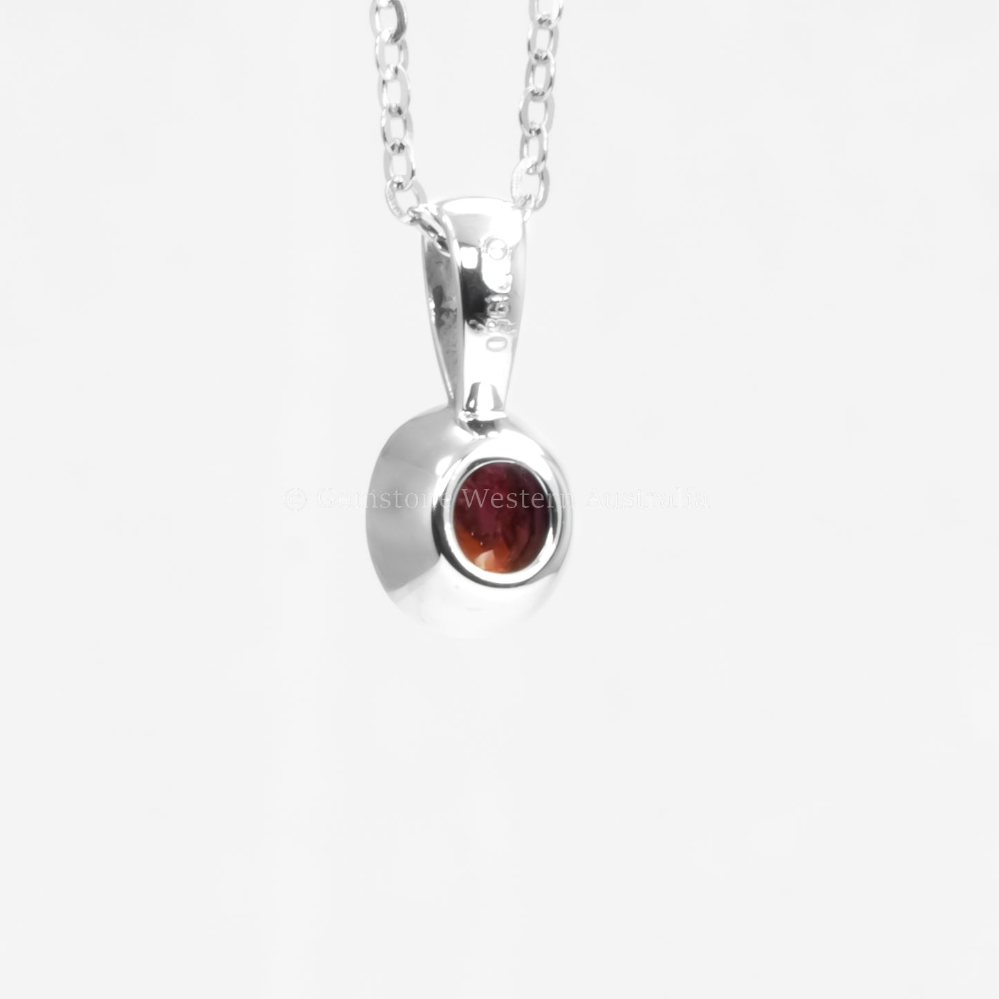 back view of Platinum pendant with natural ruby in white background