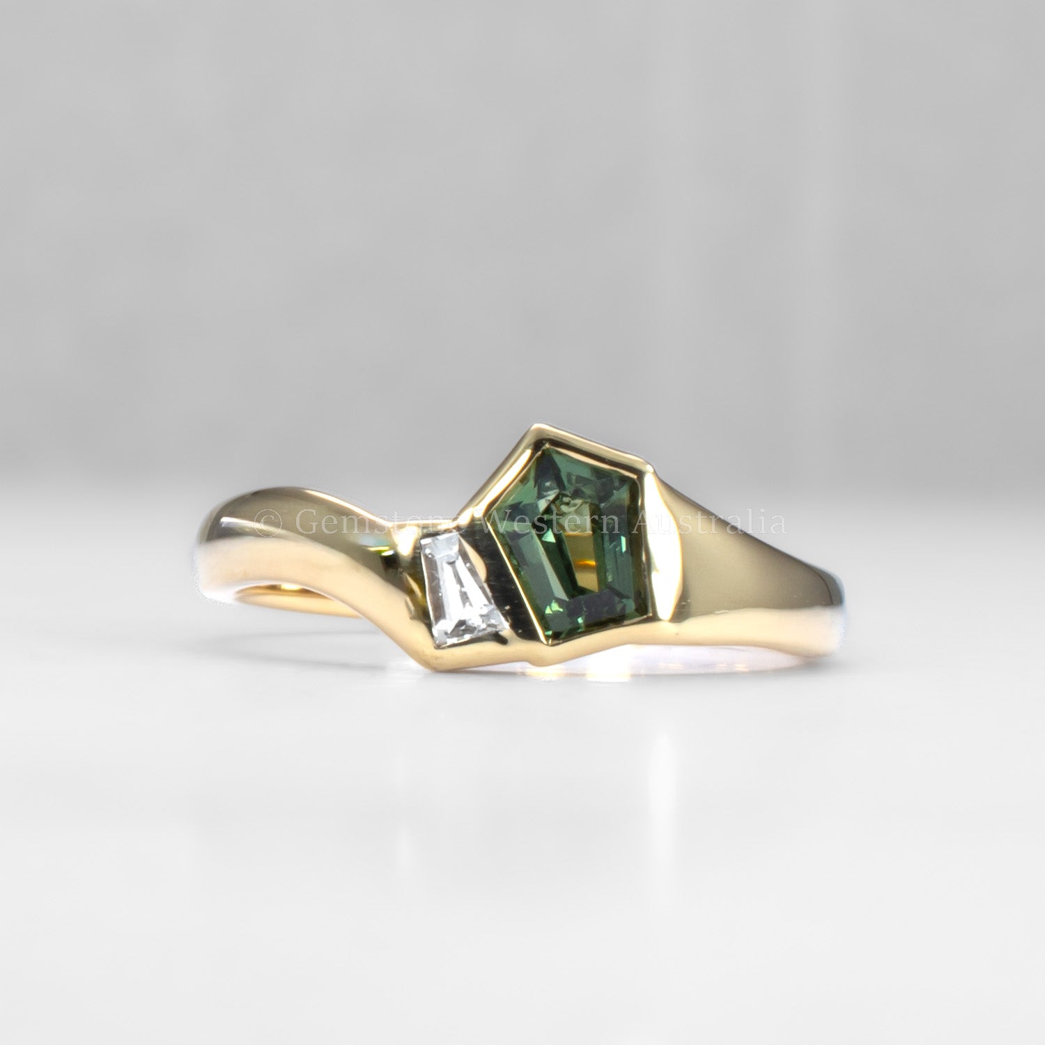 Gold ring with green gemstone