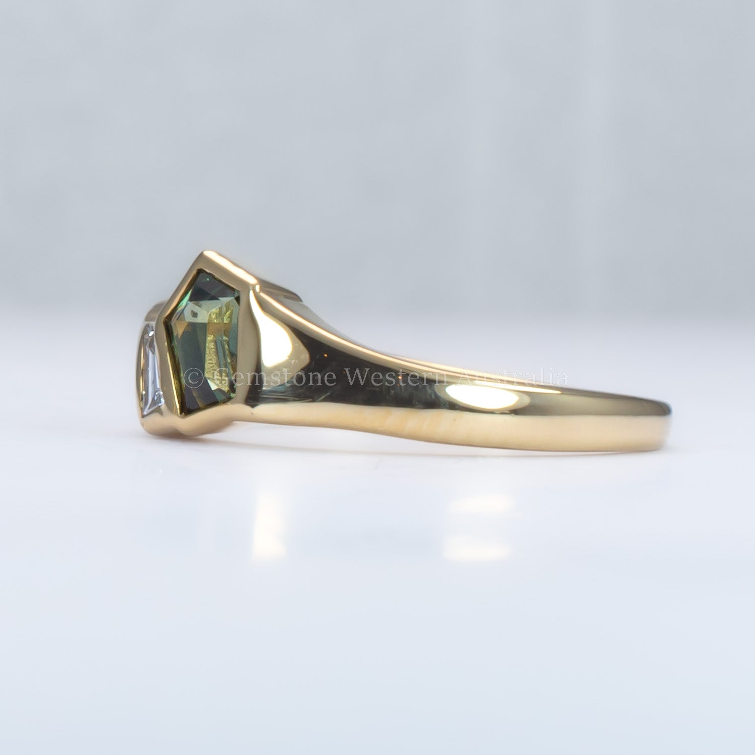 Gold ring with a green gemstone