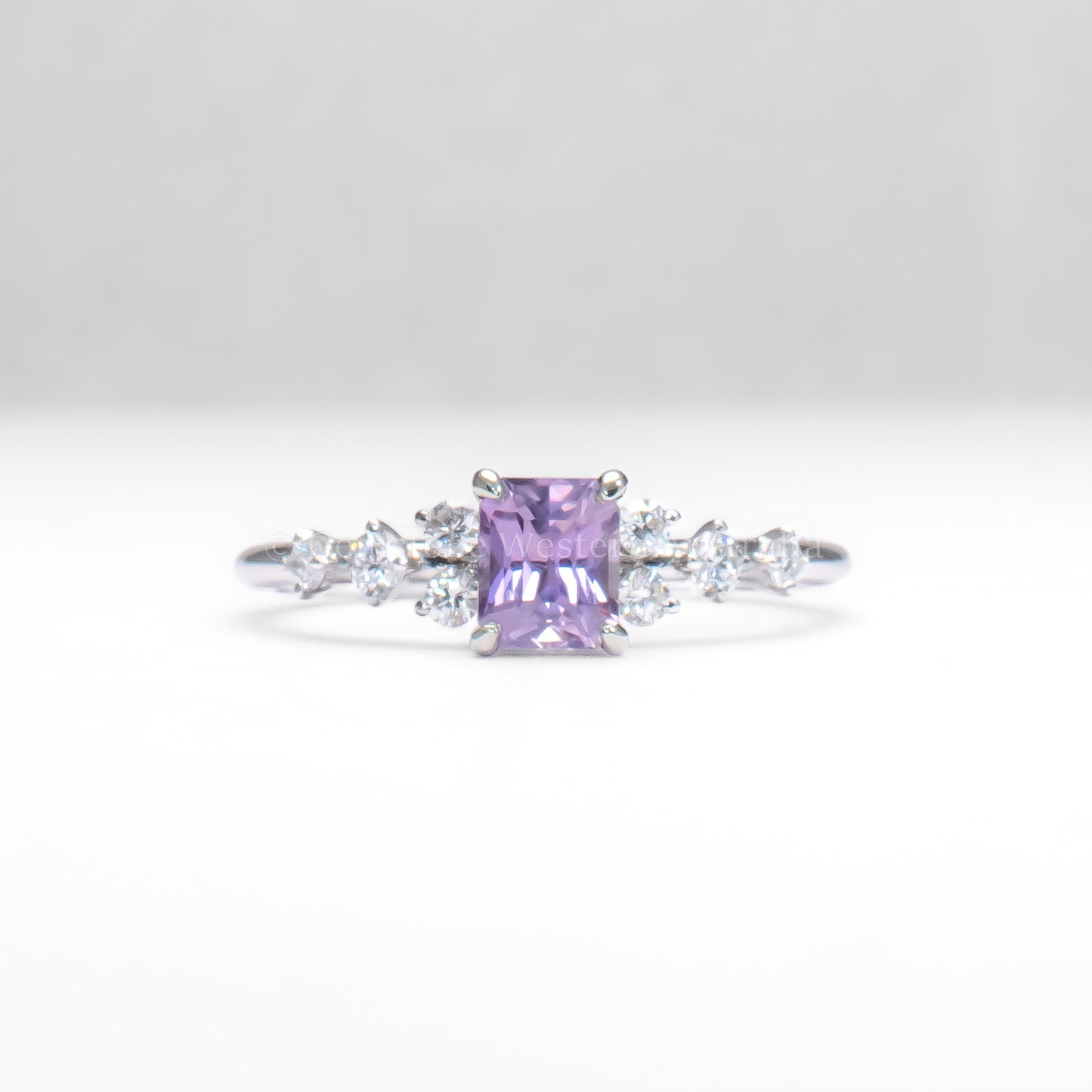 Platinum pink sapphire ring with natural diamonds in gray background