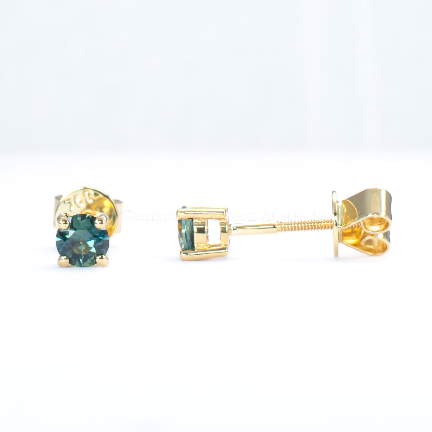 front and side view of Australian teal blue sapphire gold stud earrings in gray background