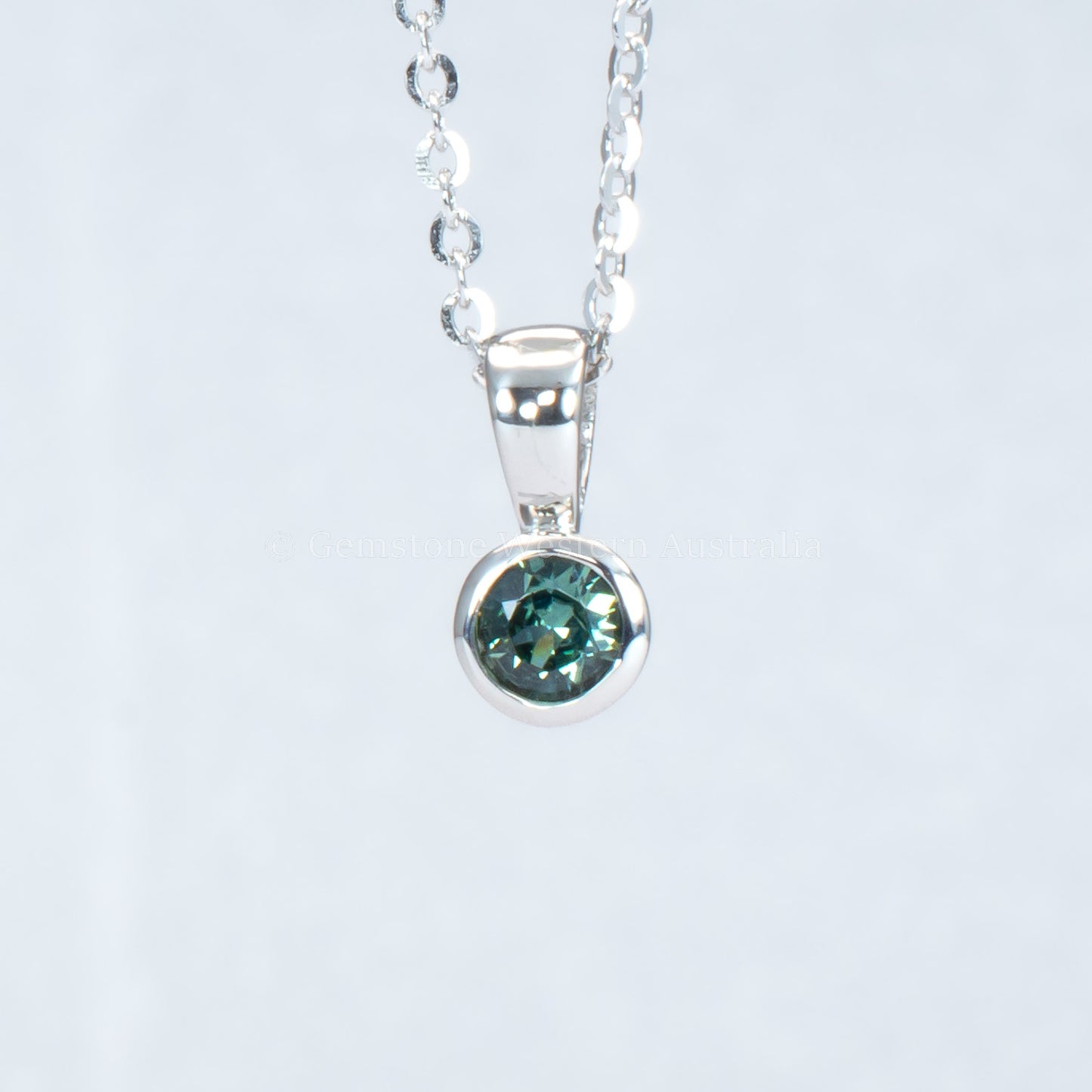 Australian teal sapphire platinum pendant in gray background