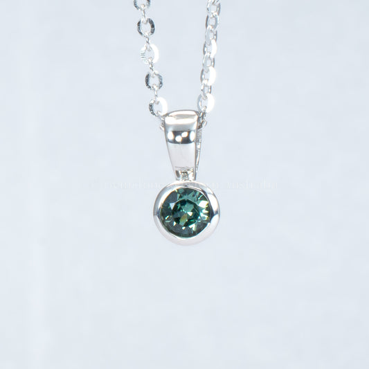 Australian teal sapphire platinum pendant in gray background
