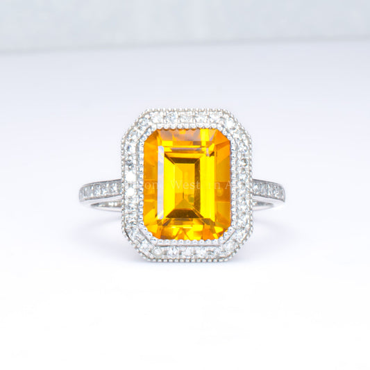 Citrine and diamond halo ring in 18K white gold in light gray background