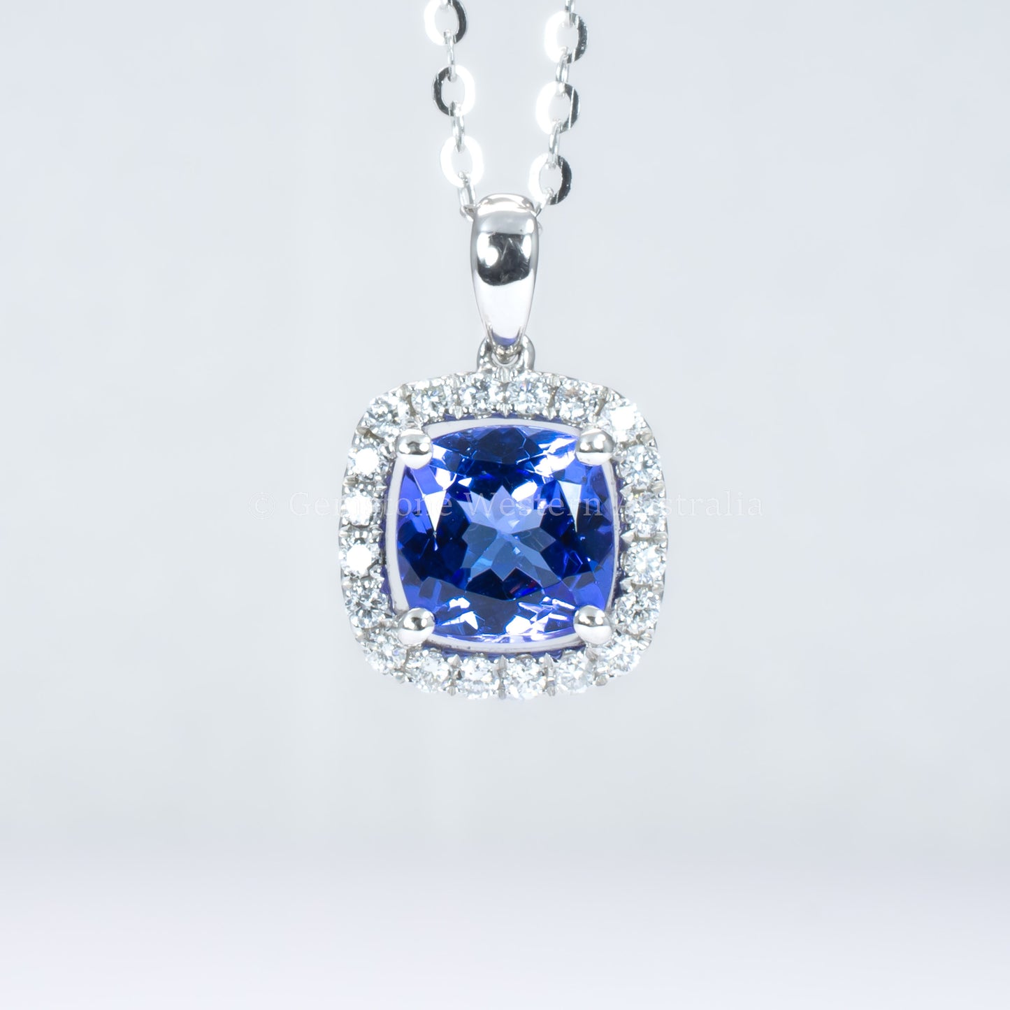 Natural tanzanite diamond pendant in white gold in gray background