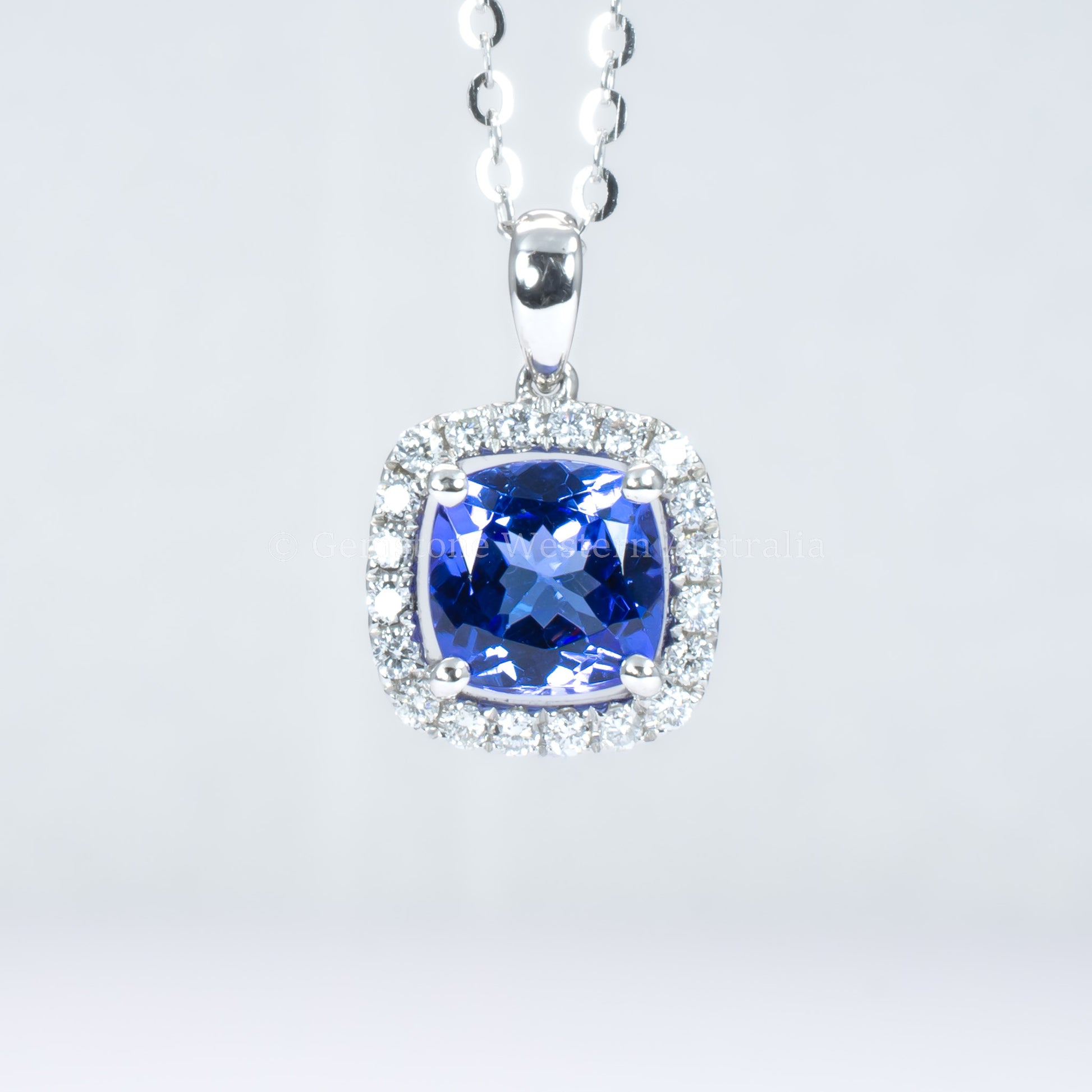 Natural tanzanite diamond pendant in white gold in gray background