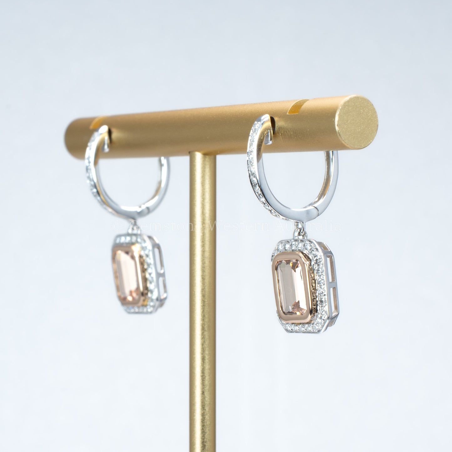 side view of morganite and diamonds gold earrings in light gray background