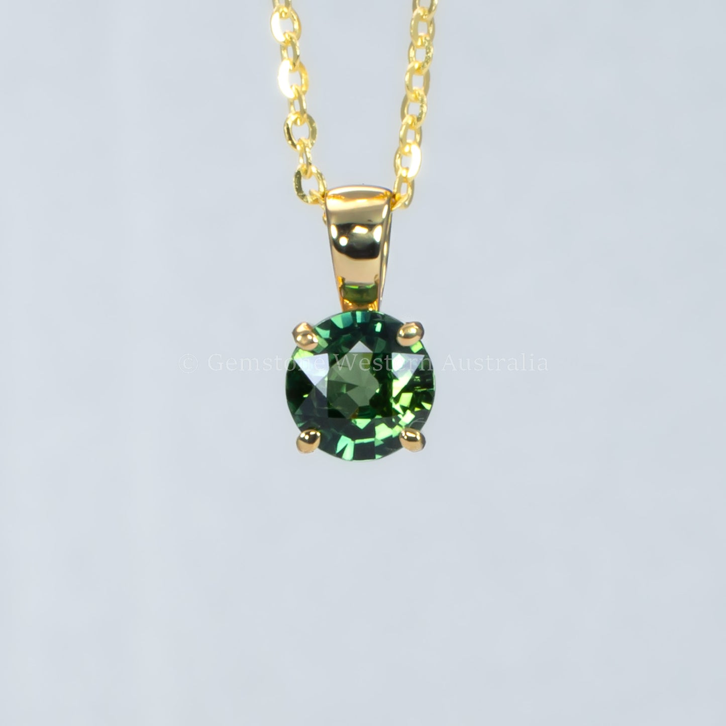 Australian teal sapphire pendant in 18K yellow gold