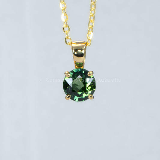 Australian teal sapphire pendant in 18K yellow gold