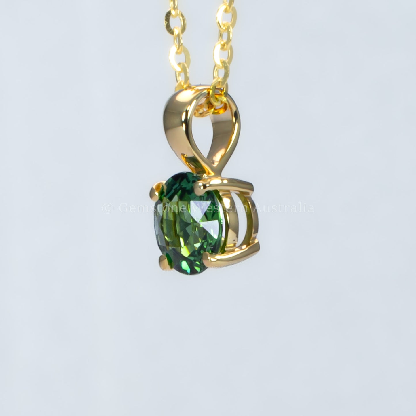 side view of Australian teal sapphire pendant in 18K yellow gold
