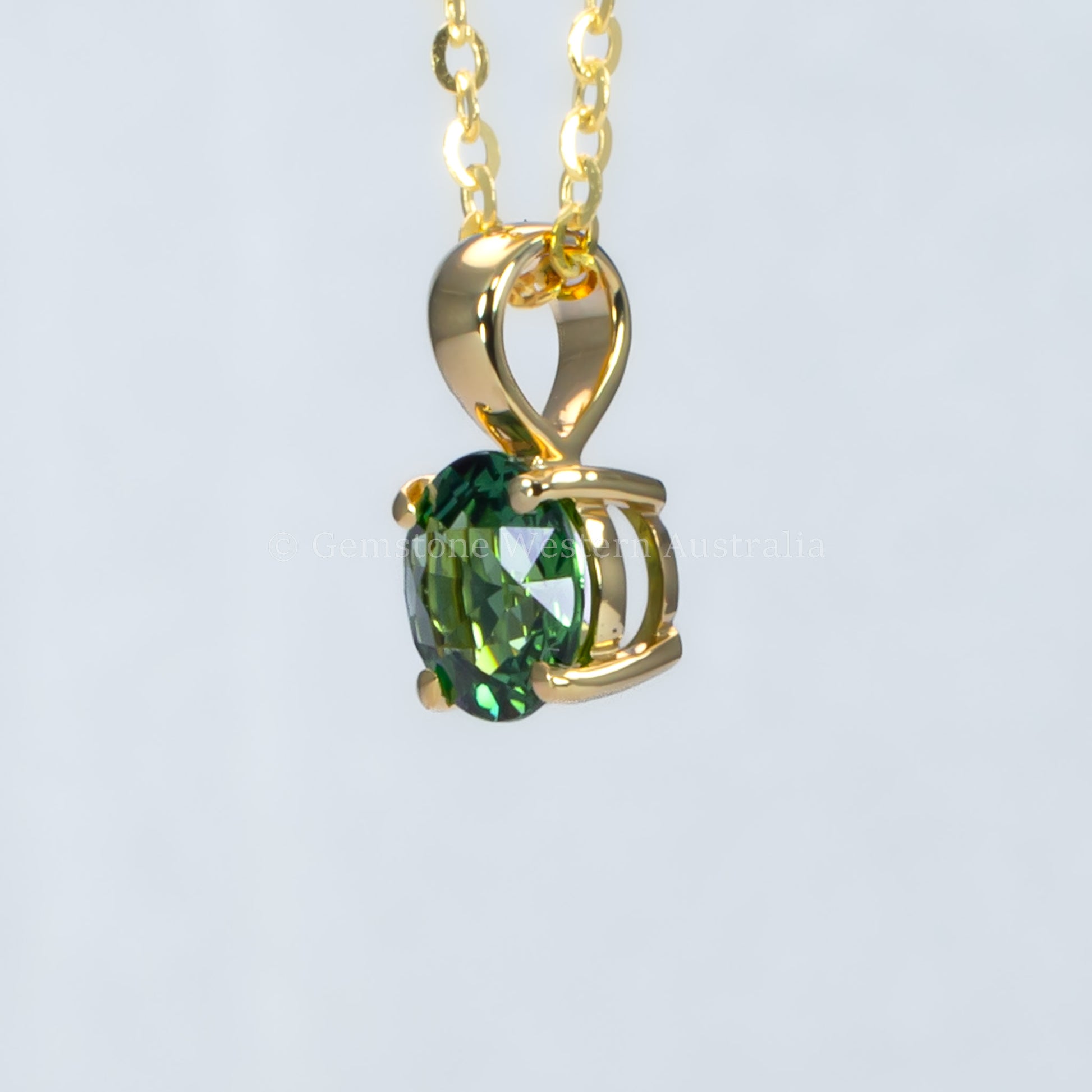 side view of Australian teal sapphire pendant in 18K yellow gold