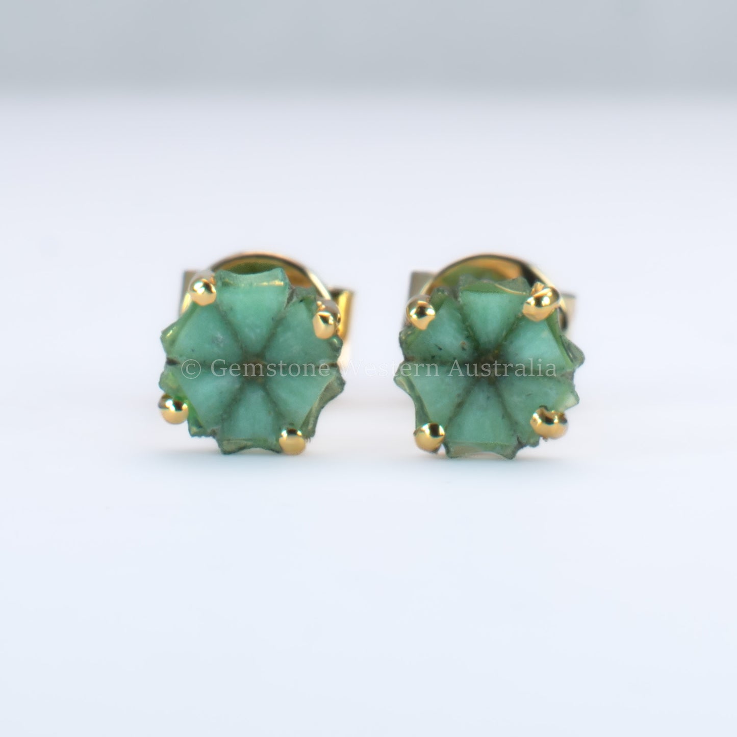 pair of natural emerald stud earrings set in  18K yellow gold