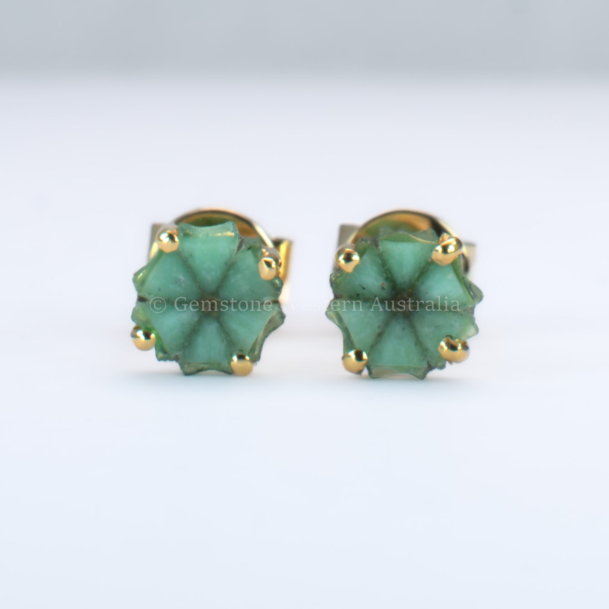pair of natural emerald stud earrings set in  18K yellow gold