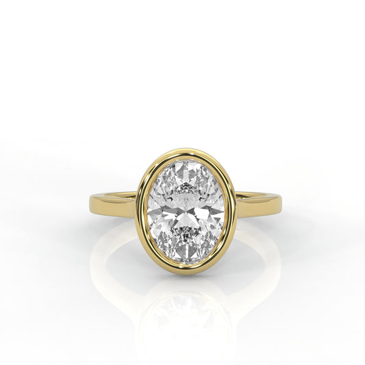 Gold bezel set ring with an Oval  diamond on a white background