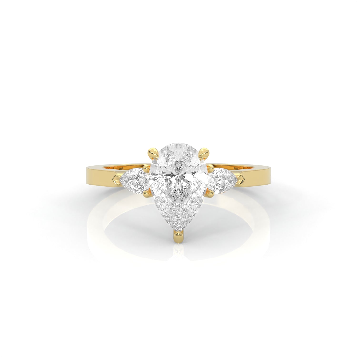 yellow gold ring with a pear-shaped diamond on a white background
