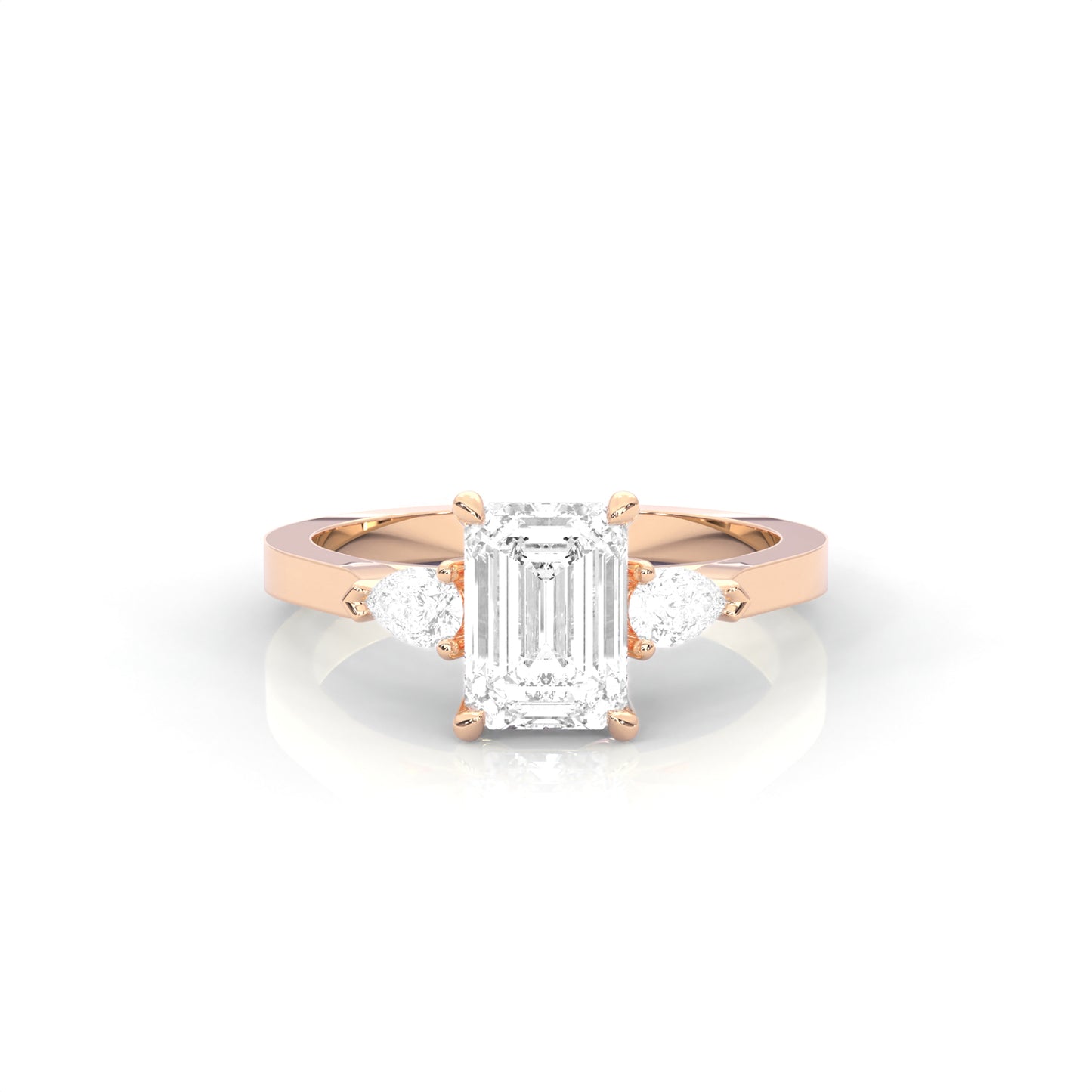 rose gold ring with emerald-cut diamond and pear diamonds on the sides against a white background