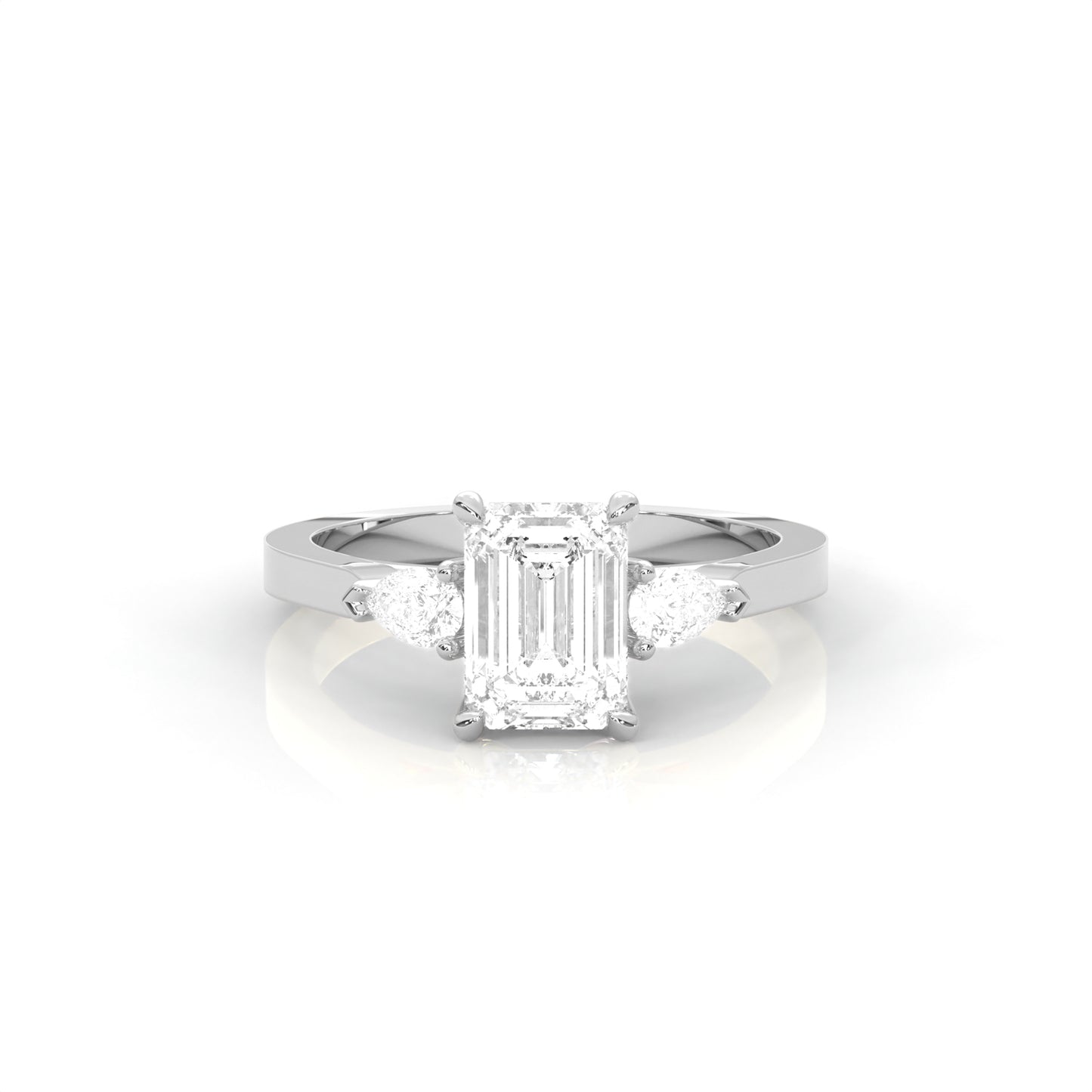 white gold ring with emerald-cut diamond and pear diamonds on the sides against a white background