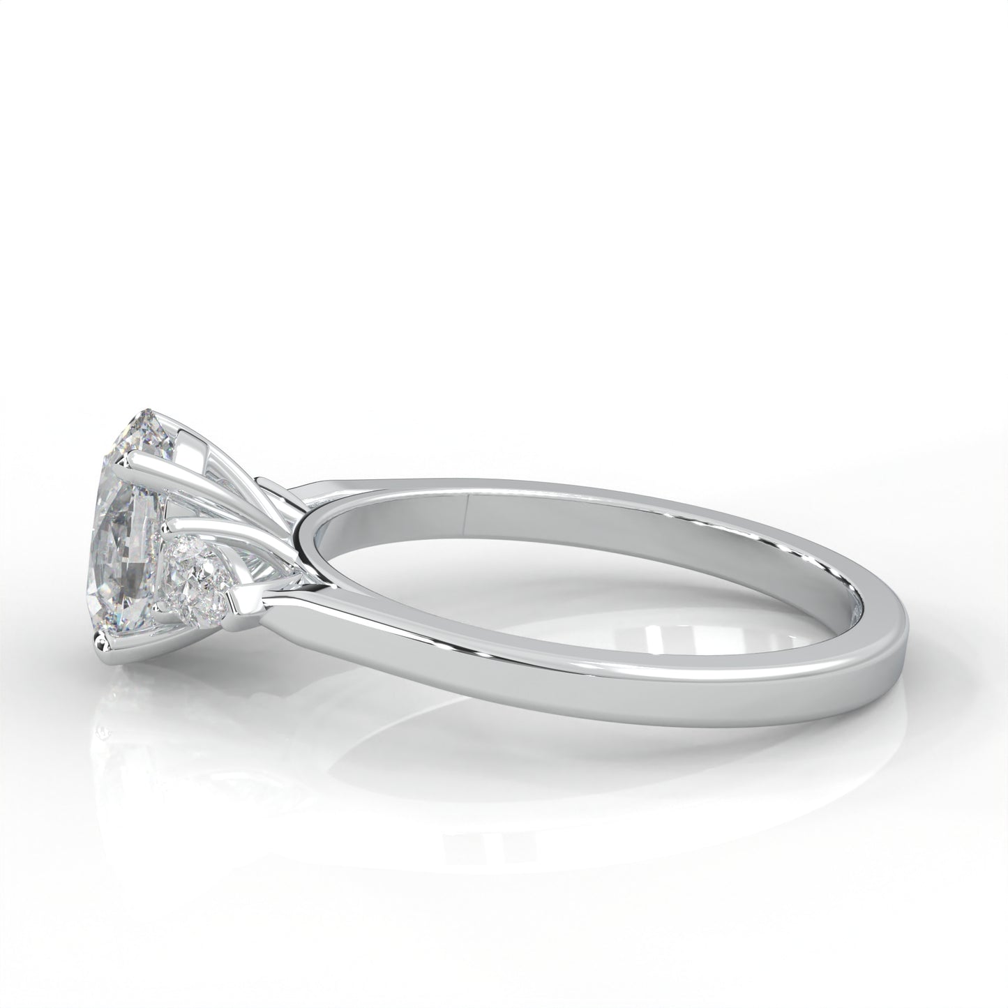 side view of Gold ring with two pear-shaped diamonds on a white background