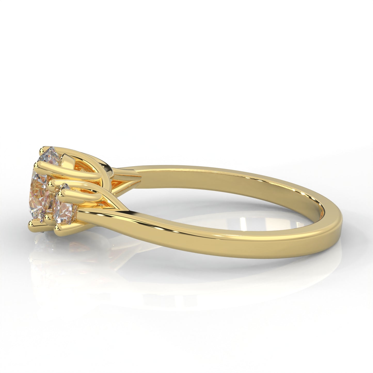 side view of yellow gold three stone ring with round side diamonds and round centre stone on white background