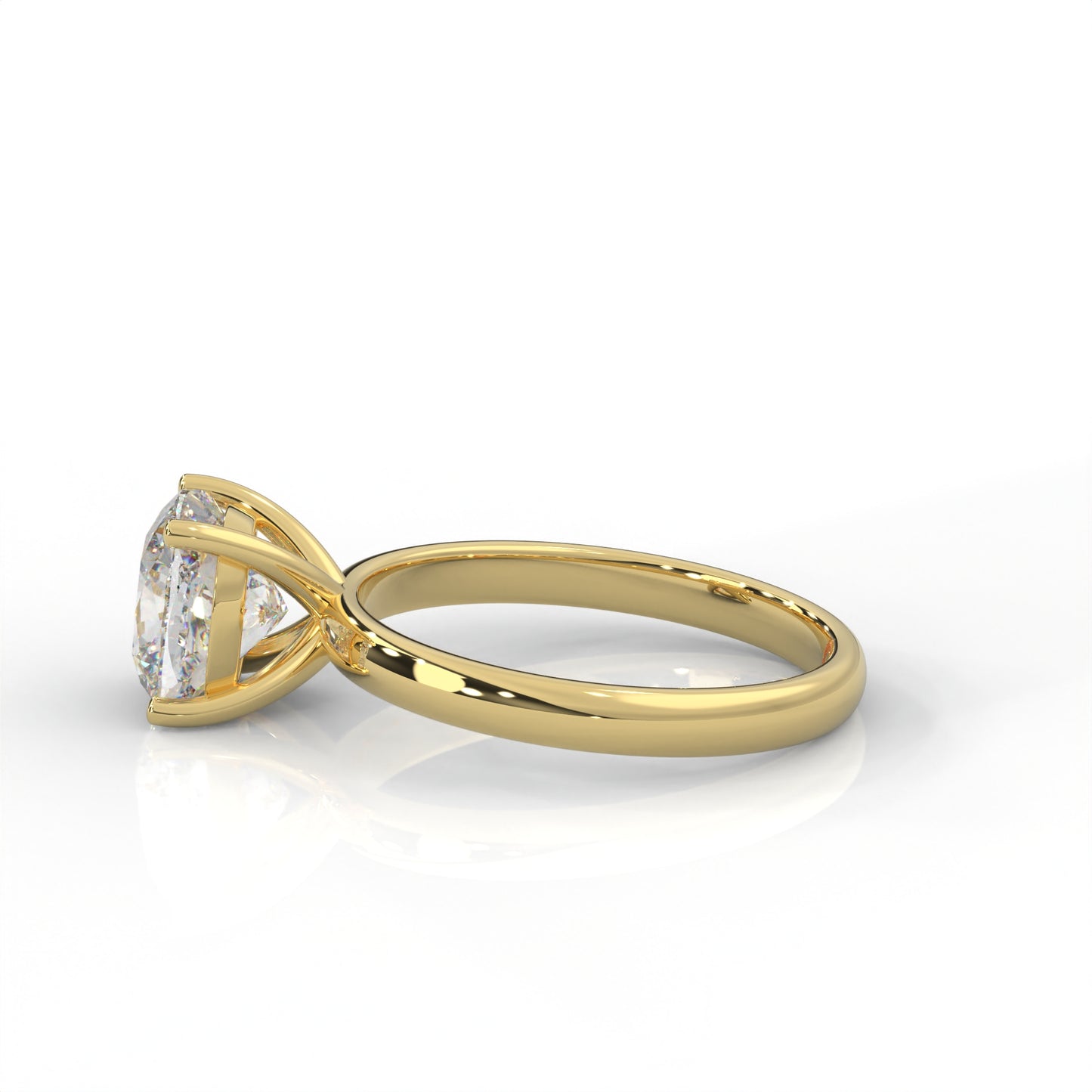 side view of Yellow gold solitaire ring with round diamond on a white background