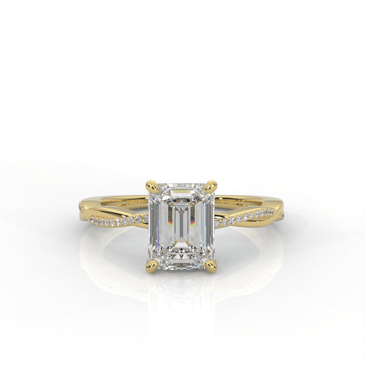 yellow gold ring with emerald-cut diamond on a white background