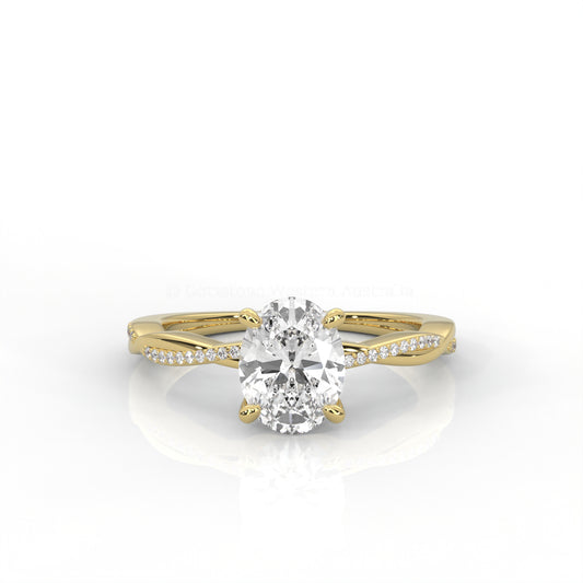 yellow gold ring with an oval-shaped diamond and twisted band on a white background