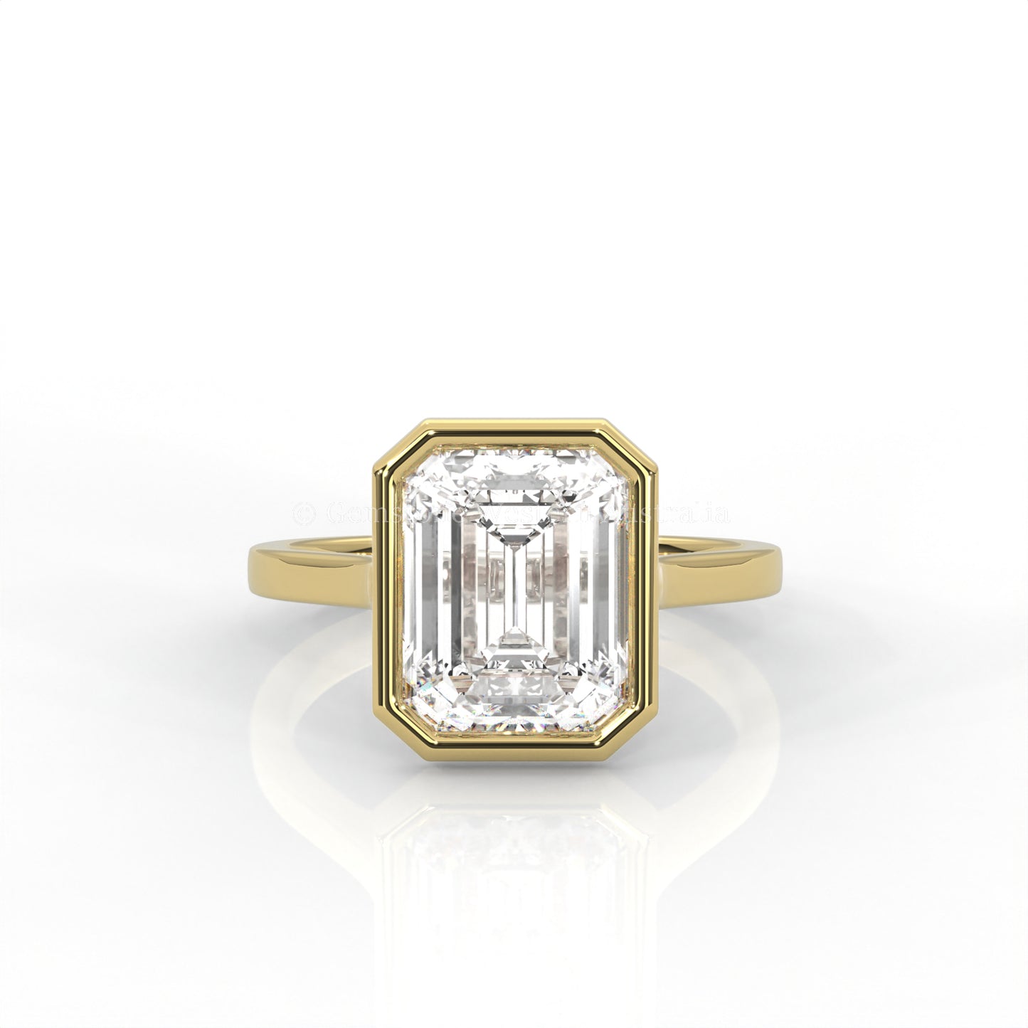 bezel set emerald-cut diamond ring in yellow gold