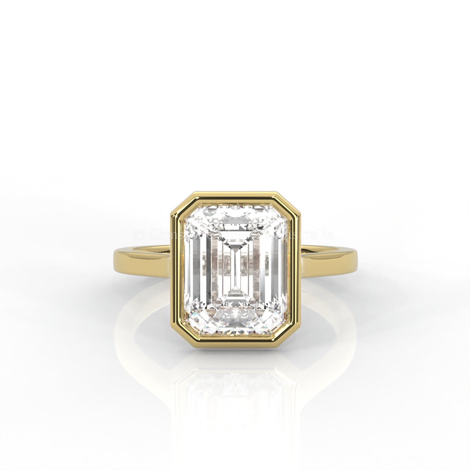 bezel set emerald-cut diamond ring in yellow gold