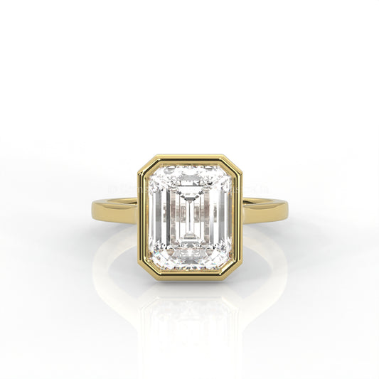 bezel set emerald-cut diamond ring in yellow gold