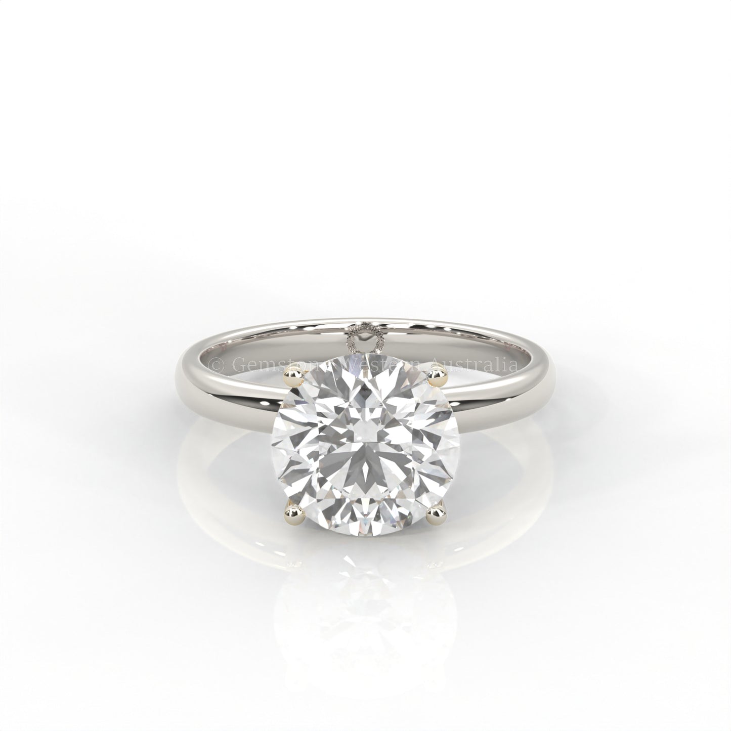 white gold solitaire ring with round diamond on a white background