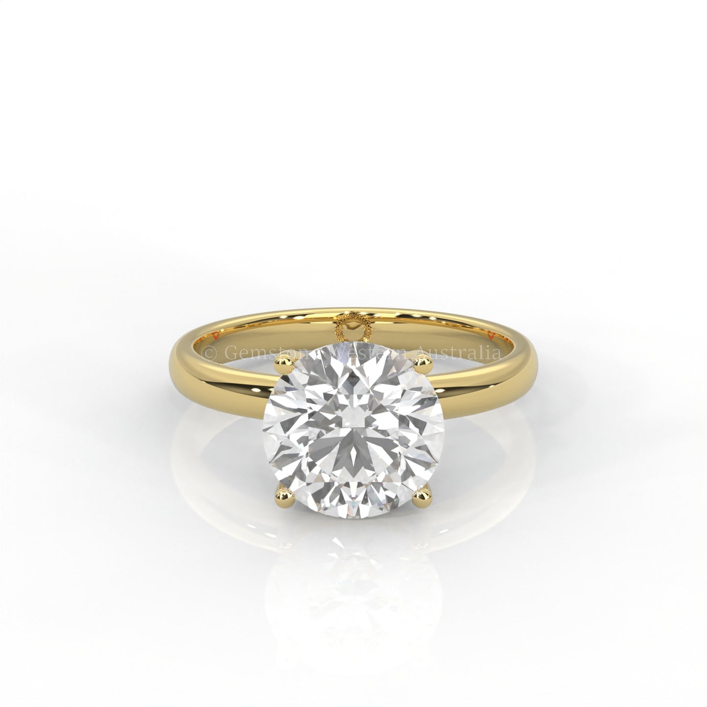 Yellow gold solitaire ring with round diamond on a white background