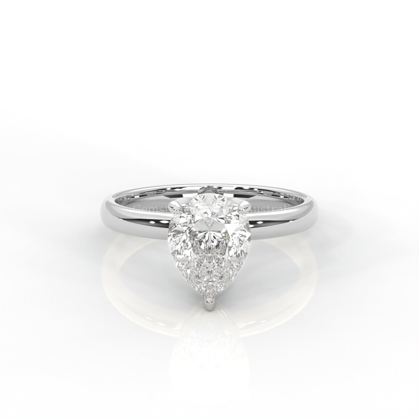 white gold solitaire ring with pear-cut diamond in a white background
