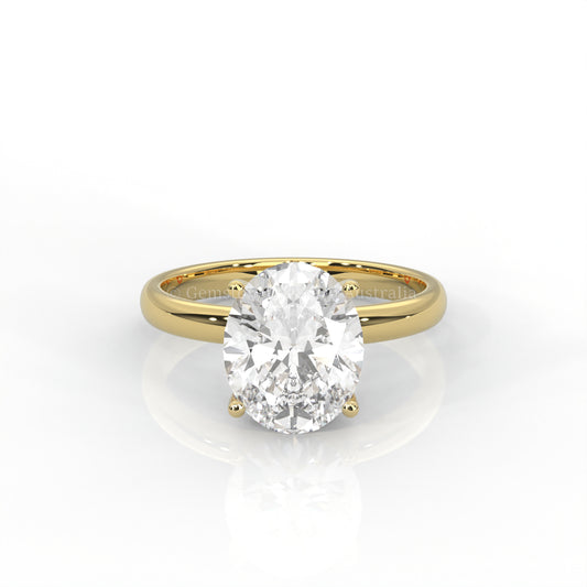 yellow gold solitaire ring with oval-cut diamond in a white background
