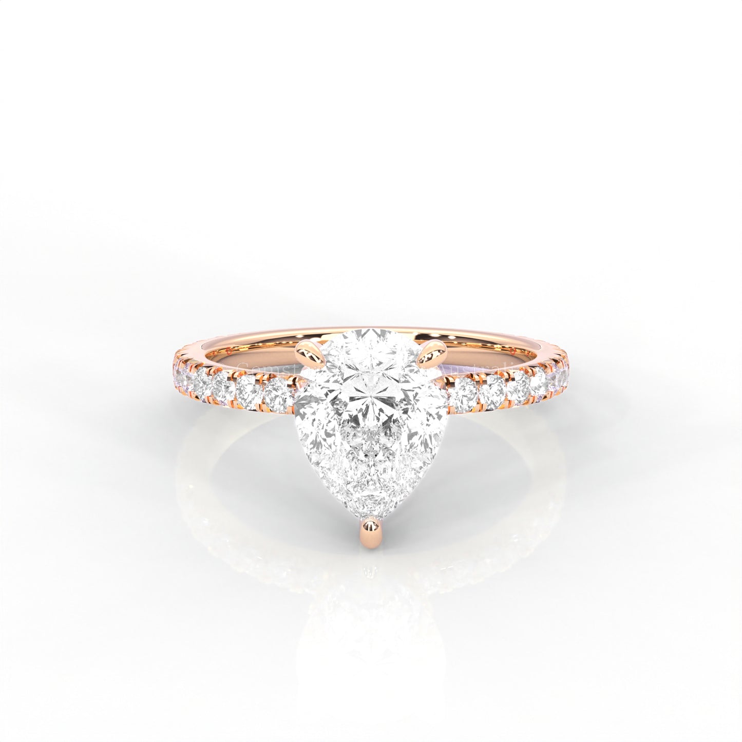 Rose gold ring with a pear-cut diamond and smaller diamonds on the band against a white background