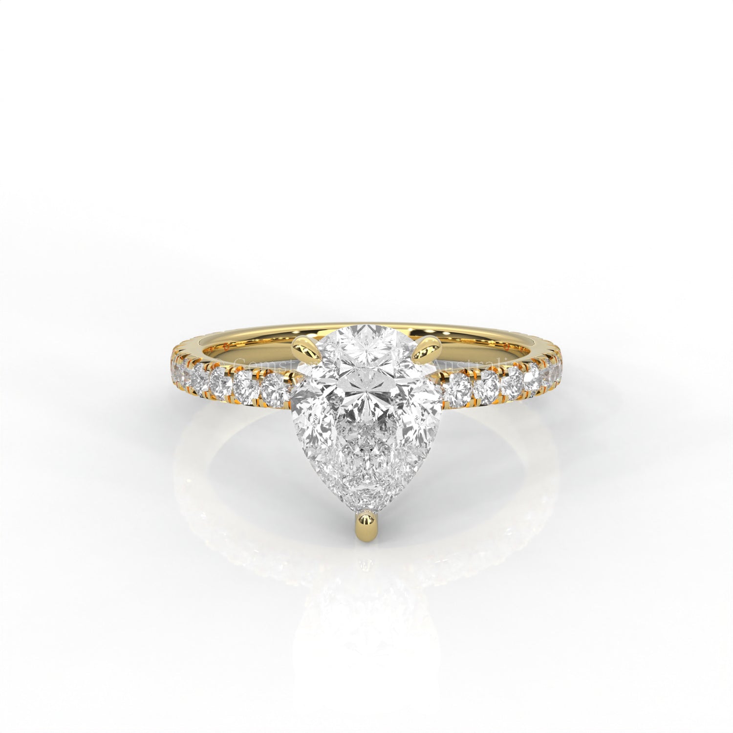 Yellow gold ring with a pear-cut diamond and smaller diamonds on the band against a white background