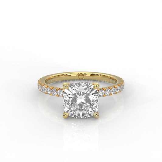 yellow gold ring with a cushion cut diamond and smaller diamonds on the band against a white background