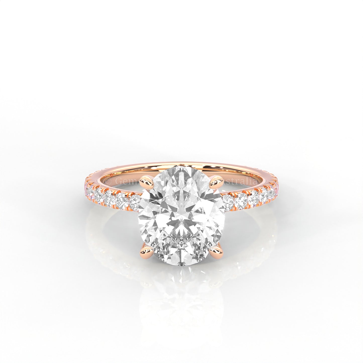 rose gold ring with an oval-cut diamond and smaller diamonds on the band against a white background