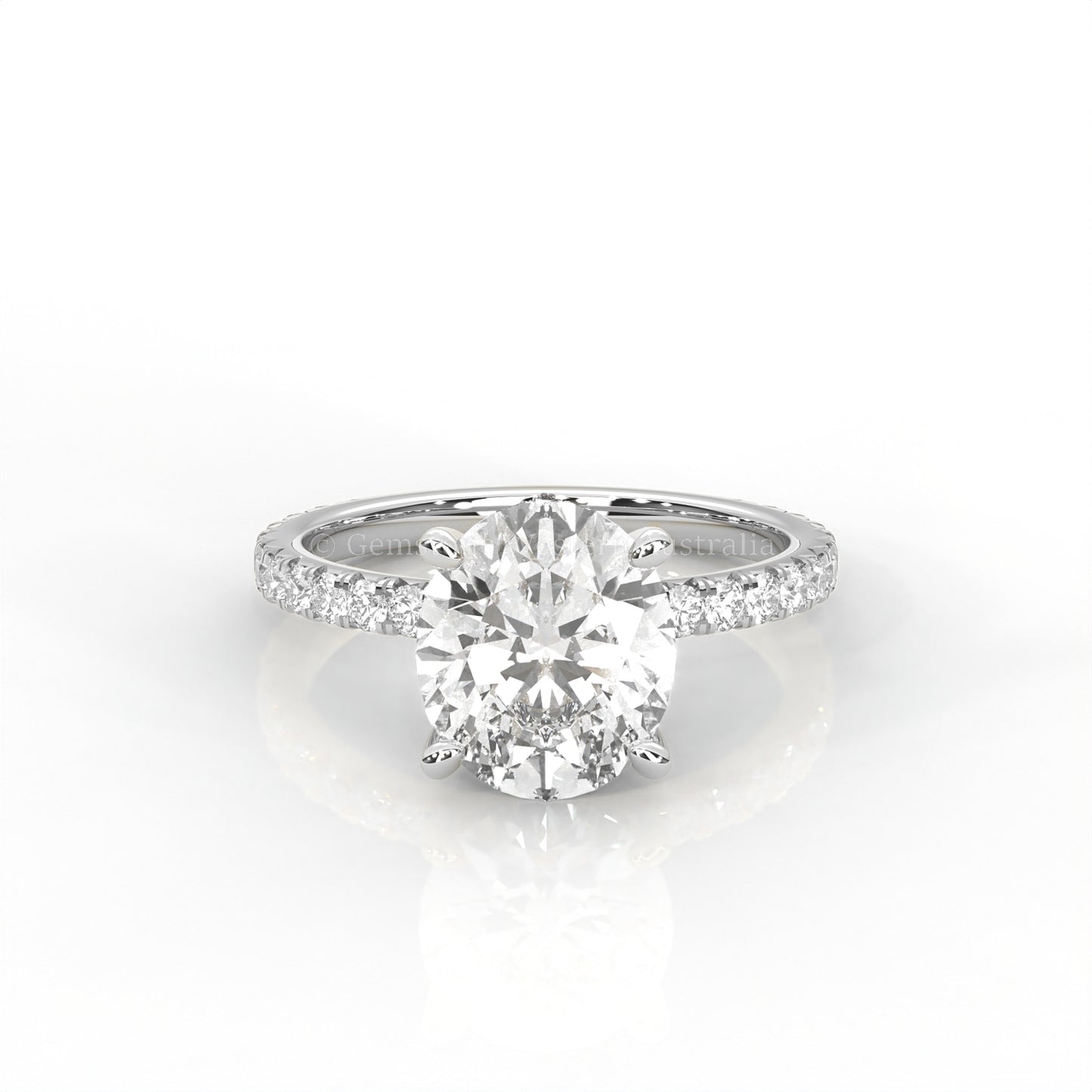 white gold ring with an oval-cut diamond and smaller diamonds on the band against a white background