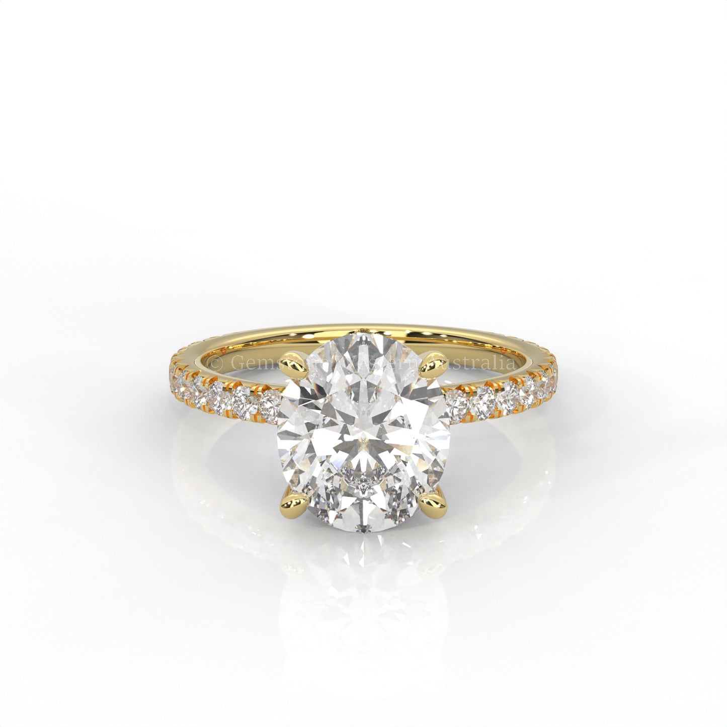 Yellow gold ring with an oval-cut diamond and smaller diamonds on the band against a white background