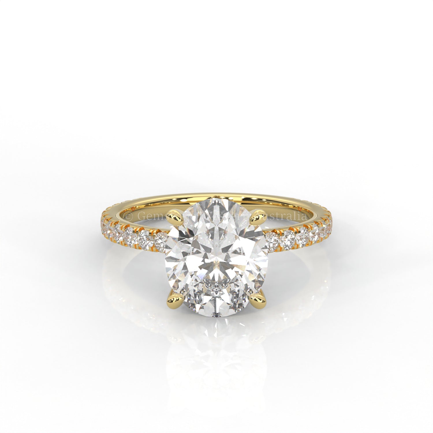 Yellow gold ring with an oval-cut diamond and smaller diamonds on the band against a white background