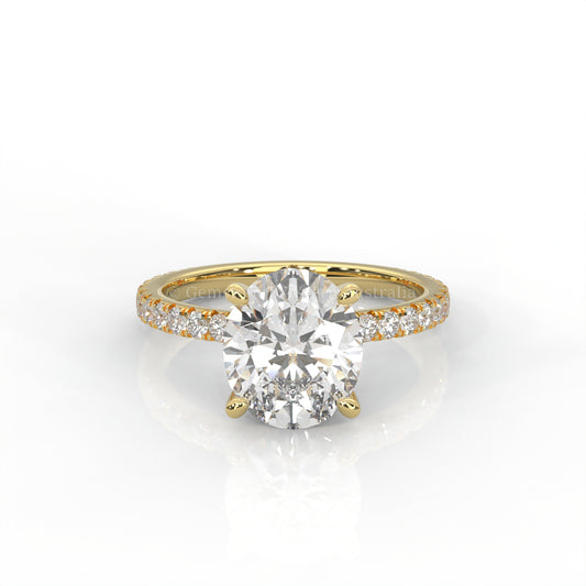Yellow gold ring with an oval-cut diamond and smaller diamonds on the band against a white background