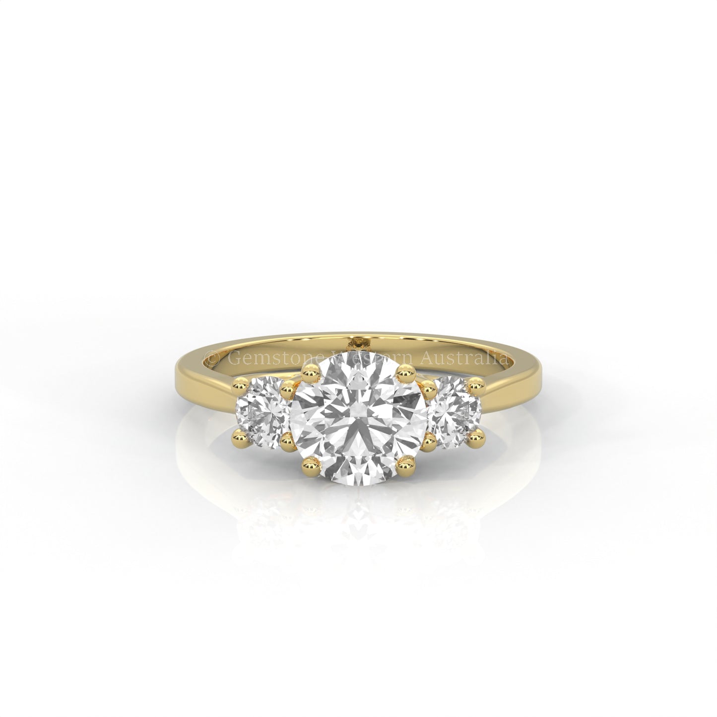 yellow gold three stone ring with round side diamonds and round centre stone on white background