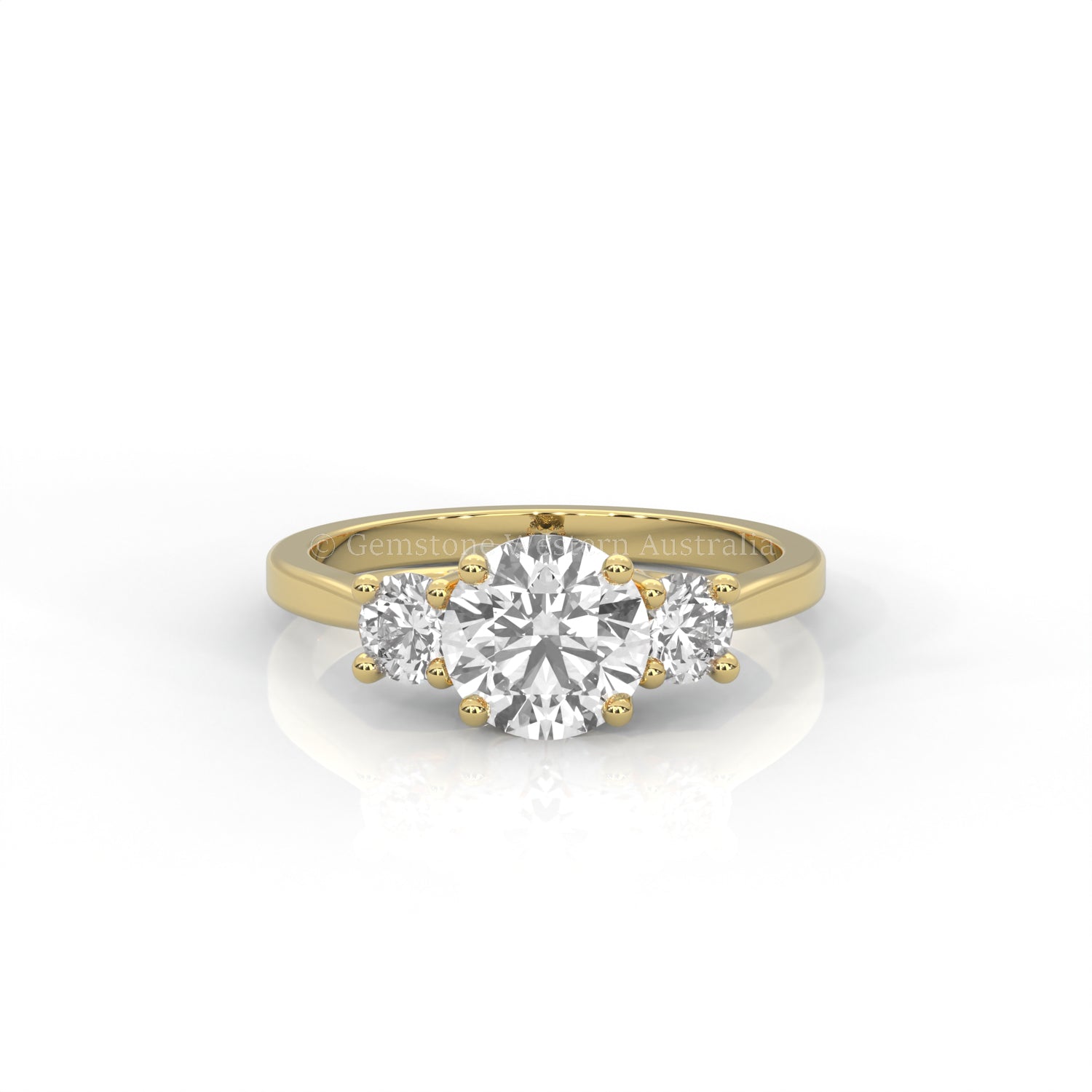 yellow gold three stone ring with round side diamonds and round centre stone on white background
