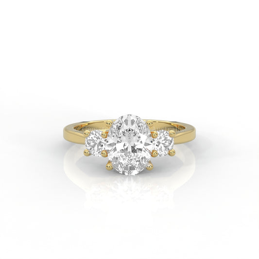 yellow gold three stone ring with round side diamonds and oval centre stone on white background