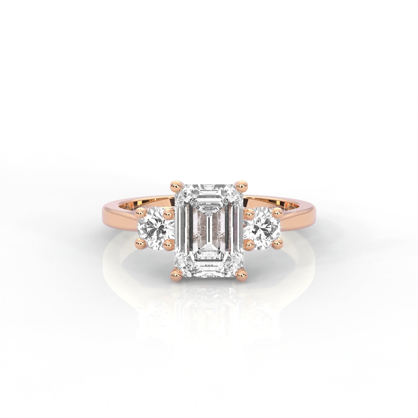 rose gold three stone ring with round side diamonds and emerald-cut centre stone on white background