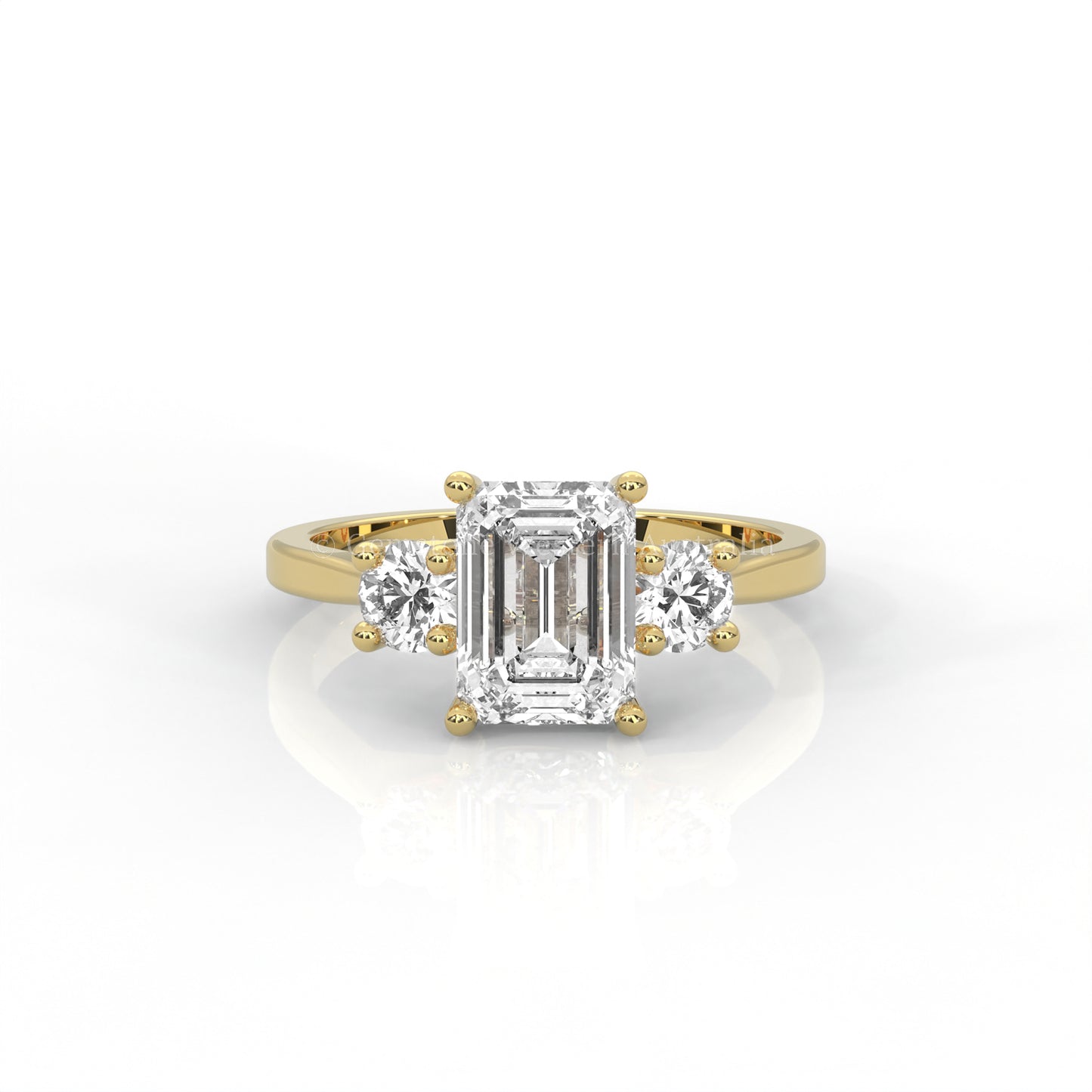 yellow gold three stone ring with round side diamonds and emerald-cut centre stone on white background