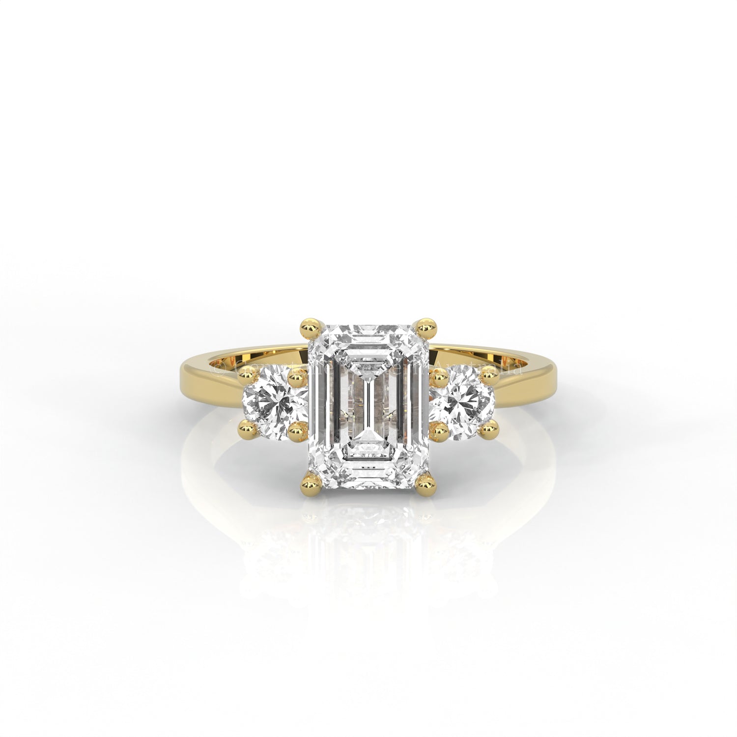 yellow gold three stone ring with round side diamonds and emerald-cut centre stone on white background