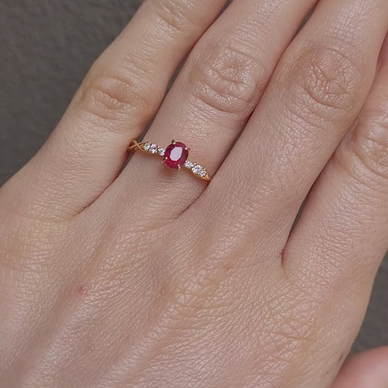 video of a Natural Ruby & Diamond Twisted Band Ring in 18K Yellow Gold worn on a hand in neutral background